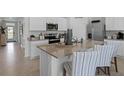 Modern kitchen with island, stainless steel appliances, and white cabinets at 2638 Sage Valley Way, Winter Haven, FL 33884