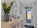 Bright entryway with decorative console table and large mirror at 2638 Sage Valley Way, Winter Haven, FL 33884