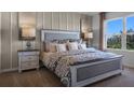 King-size bed in a bright bedroom with large window at 2634 Sage Valley Way, Winter Haven, FL 33884