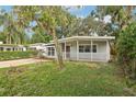 Cute house exterior with a covered porch and landscaping at 4221 Mizell St, Orlando, FL 32812