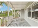 Inviting front porch with white railings and grey flooring at 4221 Mizell St, Orlando, FL 32812