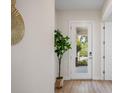 Bright entryway with white door, hardwood floors and potted plant at 1020 W Princeton St, Orlando, FL 32804