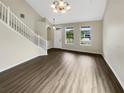 Bright living room featuring hardwood floors and a staircase at 10472 Eastpark Lake Dr, Orlando, FL 32832