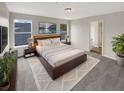 Large main bedroom with carpeted floor, large windows, and ensuite bathroom at 10472 Eastpark Lake Dr, Orlando, FL 32832