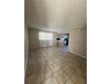 Open living room with tile flooring and kitchen view at 5505 Hernandes Dr # 238, Orlando, FL 32808
