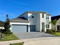 Two-story home with gray garage doors and teal front door at 58 Overleaf Ln, Orlando, FL 32839