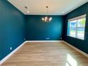 Elegant dining room with teal walls and hardwood floors at 58 Overleaf Ln, Orlando, FL 32839