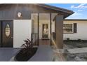 Renovated home entryway with a new door and landscaping at 2259 Howland Blvd, Deltona, FL 32738