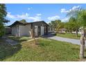 Newly renovated home with a decorative screen wall and manicured lawn at 2259 Howland Blvd, Deltona, FL 32738