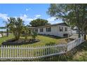 Newly renovated home with a white picket fence and manicured lawn at 2259 Howland Blvd, Deltona, FL 32738