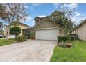 Two-story house with a large driveway and well-manicured lawn at 1716 Harris Hawk Rd, Orlando, FL 32837