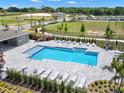 Community pool with lounge chairs and a shaded area at 6118 Galloping Dr, Apopka, FL 32712