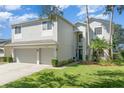 Two-story house with a two-car garage and well-manicured lawn at 15543 Pebble Ridge St, Winter Garden, FL 34787