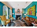 Vibrant living room with bold colors, unique artwork, and comfortable seating at 2228 Azalea Pl, Winter Park, FL 32789
