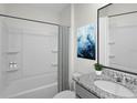 Clean bathroom with a shower/tub combo and granite vanity at 2526 Sage Valley Way, Winter Haven, FL 33884