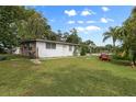 Side yard view of home with grassy area at 621 Oaklando Dr, Altamonte Springs, FL 32714