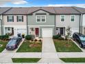 Aerial view of three townhouses with attached garages at 947 Grandin St, Davenport, FL 33837