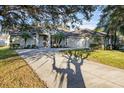 House exterior showcasing a large tree and driveway at 2551 Oak Hammock Preserve Blvd, Kissimmee, FL 34746