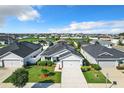 Aerial view of a house with a gray exterior and solar panels at 653 Persian Dr, Haines City, FL 33844