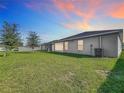 Spacious backyard with grassy lawn and AC unit at 653 Persian Dr, Haines City, FL 33844