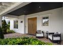 Inviting front porch with wooden doors and comfortable seating at 830 Oakdale St, Windermere, FL 34786