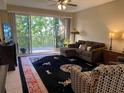 Living room with comfy seating and large windows at 6312 Buford St # 304, Orlando, FL 32835