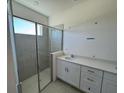 Spacious bathroom with double vanity and a walk-in shower at 3112 Windswept Way, Wildwood, FL 34785
