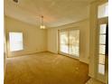 Spacious dining area with large windows and neutral decor at 8647 Otter Creek Ct, Orlando, FL 32829