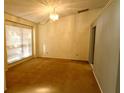 Bright dining room with large window, neutral walls, and carpet flooring at 8647 Otter Creek Ct, Orlando, FL 32829