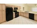 Bright kitchen features black appliances and light wood cabinets at 8647 Otter Creek Ct, Orlando, FL 32829