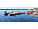 Wooden boat docks extending into a calm lake at 151 North Orlando Avenue # 142, Winter Park, FL 32789