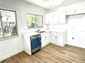 Modern kitchen with white shaker cabinets, stainless steel appliances and dishwasher at 666 Sausalito Blvd, Casselberry, FL 32707