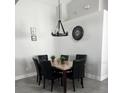 Elegant dining room with a marble table and six black chairs at 2521 Oneida Loop, Kissimmee, FL 34747