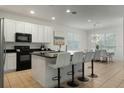 Modern kitchen with white cabinets, a large island, and stainless steel appliances at 4511 Monado Dr, Kissimmee, FL 34746