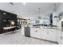 Modern kitchen with white cabinets, stainless steel appliances, and an island at 4537 Target Blvd, Kissimmee, FL 34746