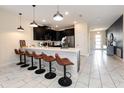 Modern kitchen with breakfast bar seating at 8896 Cabot Cliffs Dr, Davenport, FL 33896
