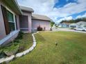 Landscaped front yard with a stone border and pathway to the house at 2146 Remington Pointe Blvd, Kissimmee, FL 34743