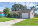 House exterior with a spacious driveway and well-kept lawn at 2319 Continental Blvd, Orlando, FL 32808