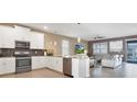 Modern kitchen features stainless steel appliances and an island at 4535 Narrative Ln, Kissimmee, FL 34746