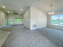 Spacious living room with carpet flooring and access to the backyard at 4394 Sagefield Dr, Harmony, FL 34773