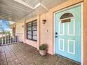 Inviting light blue front door entrance with tiled porch at 810 S Galena Ave, Minneola, FL 34715