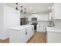 Modern kitchen with white cabinets, quartz countertops, and an island at 2822 Brookline Ave, New Smyrna Beach, FL 32168