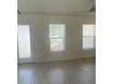 Bright living room with wood-look flooring and windows at 13394 Sw 106Th St, Dunnellon, FL 34432