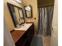 Clean bathroom with single sink vanity, shower, and decorative curtain at 2456 Sweetwater Club Cir # 20, Kissimmee, FL 34746