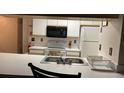 Cozy kitchen featuring white cabinetry, microwave, and stove at 2456 Sweetwater Club Cir # 20, Kissimmee, FL 34746