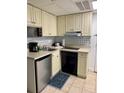 Small kitchen with appliances and corner sink at 6165 Carrier Dr # 2113, Orlando, FL 32819
