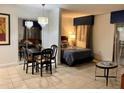 Open studio apartment featuring a dining area, bed, and sitting area at 6165 Carrier Dr # 2113, Orlando, FL 32819