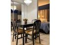 Bright dining area with table and four chairs, adjacent to bedroom at 6165 Carrier Dr # 2113, Orlando, FL 32819