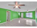 Green living room with tile floors, stairs, and ceiling fan at 6295 River Run Pl # 199, Orlando, FL 32807