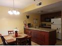 Kitchen with granite countertops and dark wood cabinets at 6337 Parc Corniche Dr # 2106, Orlando, FL 32821
